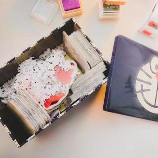 A box full of stickers and Godzilla paper confetti